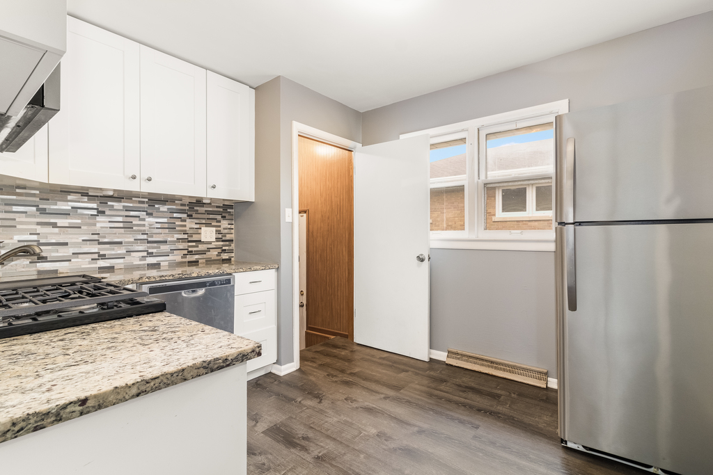 466 East Butterfield Road Elmhurst, IL 60126 - Photo 4 of 11 a kitchen with a refrigerator stove and cabinets