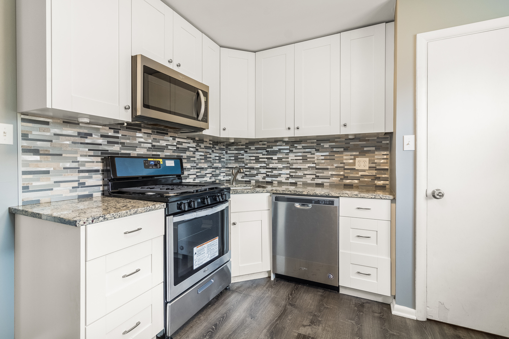 466 East Butterfield Road Elmhurst, IL 60126 - Photo 5 of 11 a kitchen with stainless steel appliances white cabinets and a stove top oven