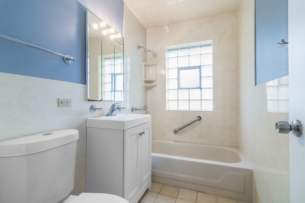 466 East Butterfield Road Elmhurst, IL 60126 - Photo 8 of 11 a bathroom with a sink a toilet and a bathtub