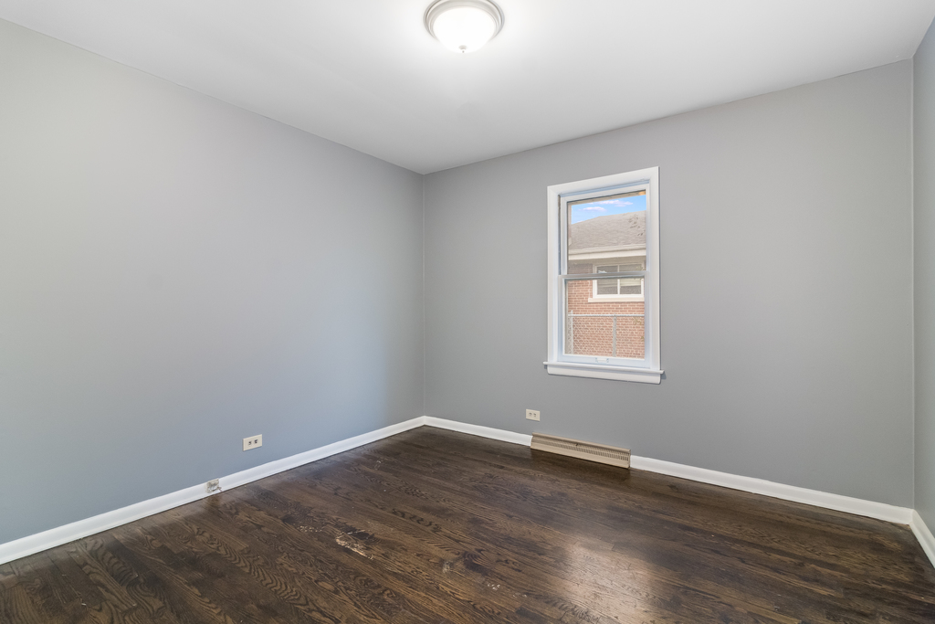 466 East Butterfield Road Elmhurst, IL 60126 - Photo 9 of 11 an empty room with wooden floor and windows