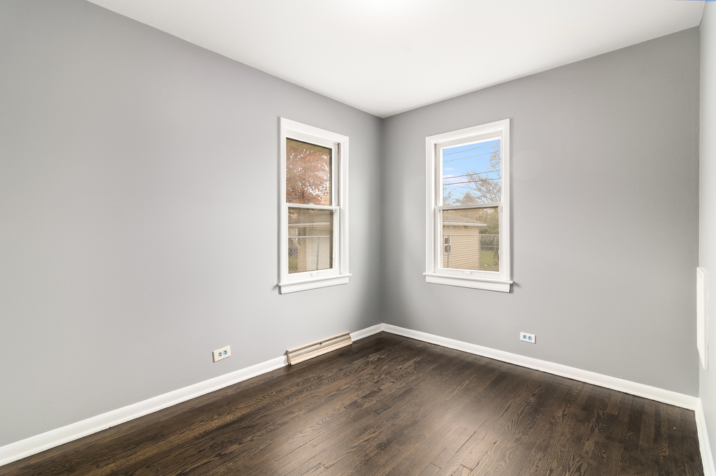 466 East Butterfield Road Elmhurst, IL 60126 - Photo 10 of 11 an empty room with wooden floor and windows