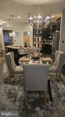 a living room with patio furniture and kitchen view