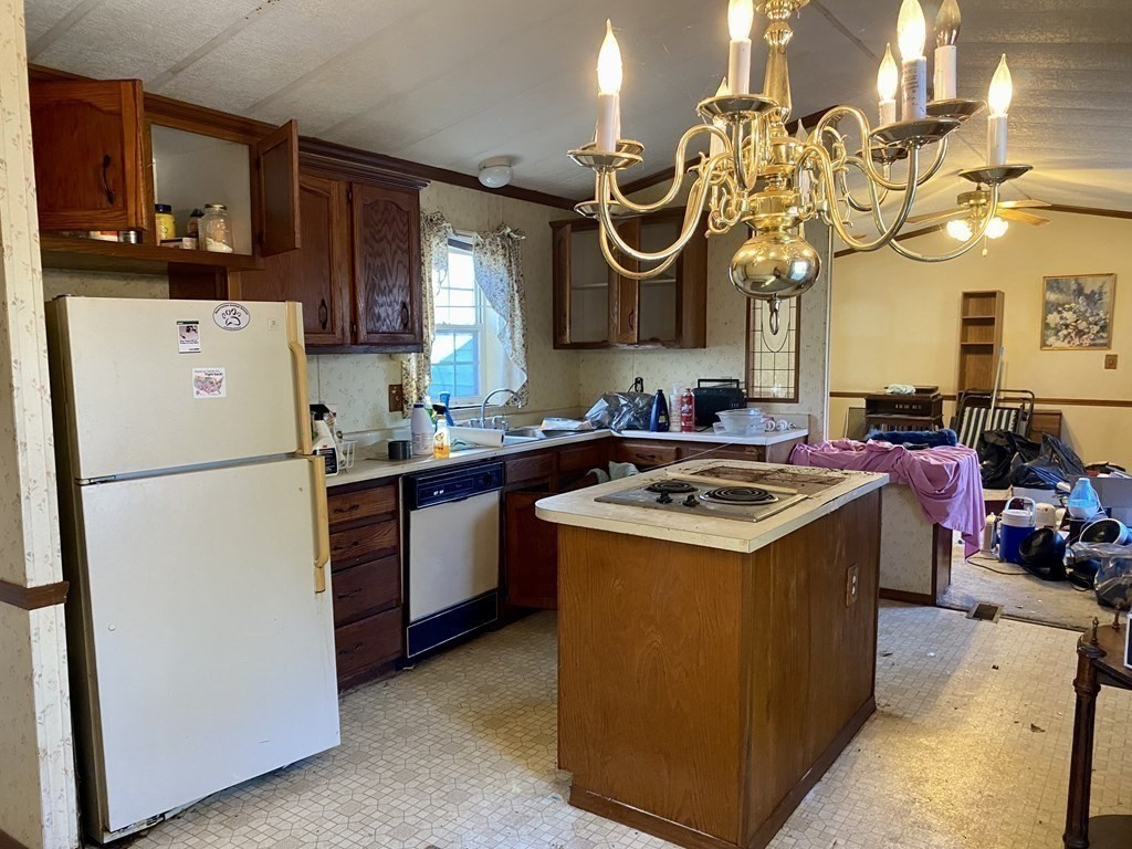 390 Patriots Road Templeton, MA 01468 - Photo 3 of 21 a kitchen with a sink a stove and refrigerator