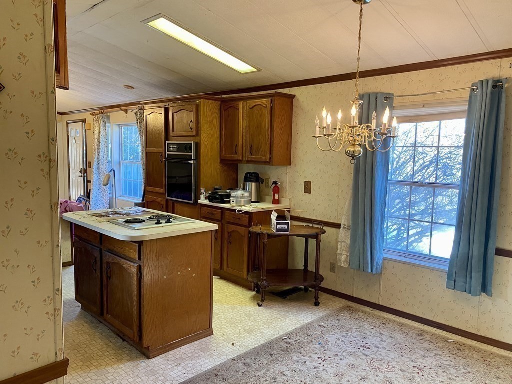 390 Patriots Road Templeton, MA 01468 - Photo 4 of 21 a kitchen that has a stove and a table in it
