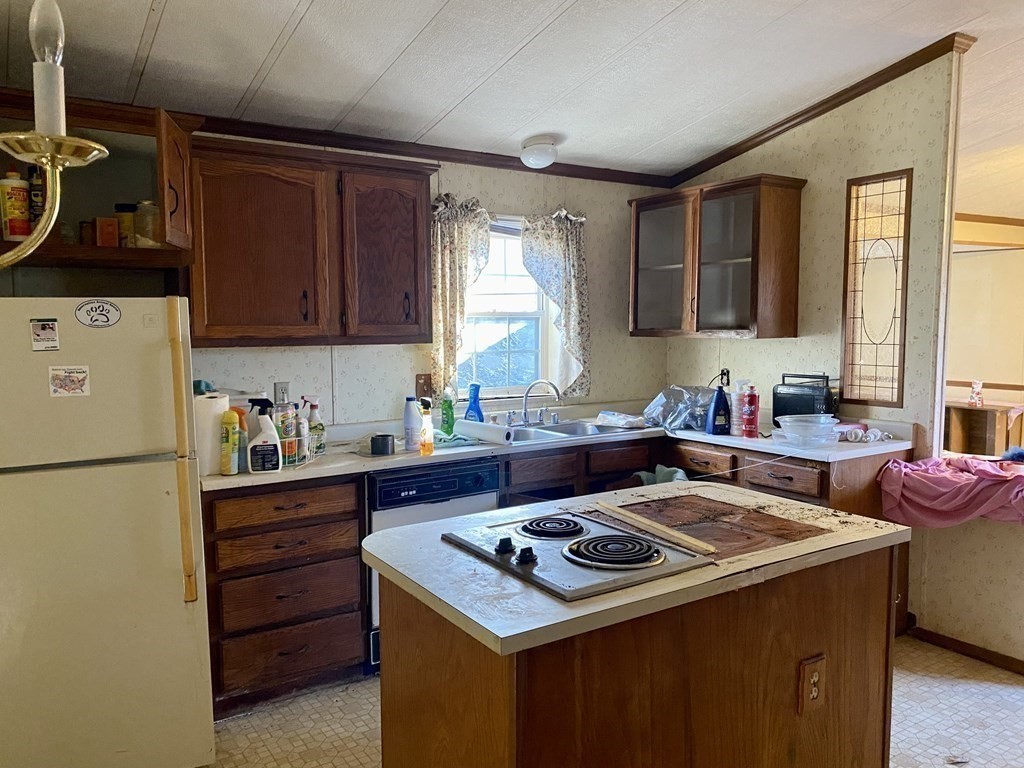 390 Patriots Road Templeton, MA 01468 - Photo 6 of 21 a kitchen with a stove a sink and a refrigerator