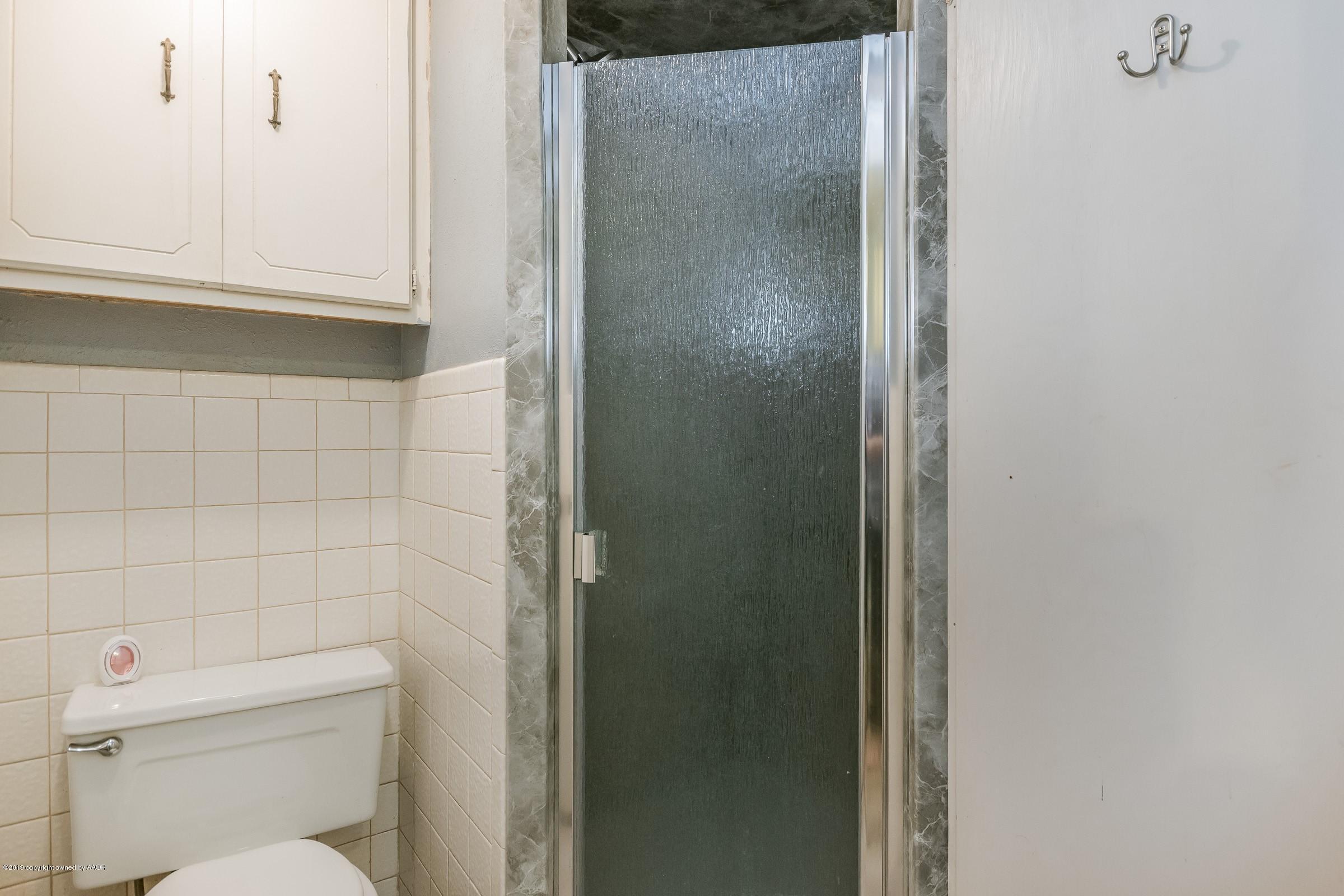 4318 Cline Road Amarillo, TX 79110 - Photo 12 of 21 a bathroom with a toilet and a shower