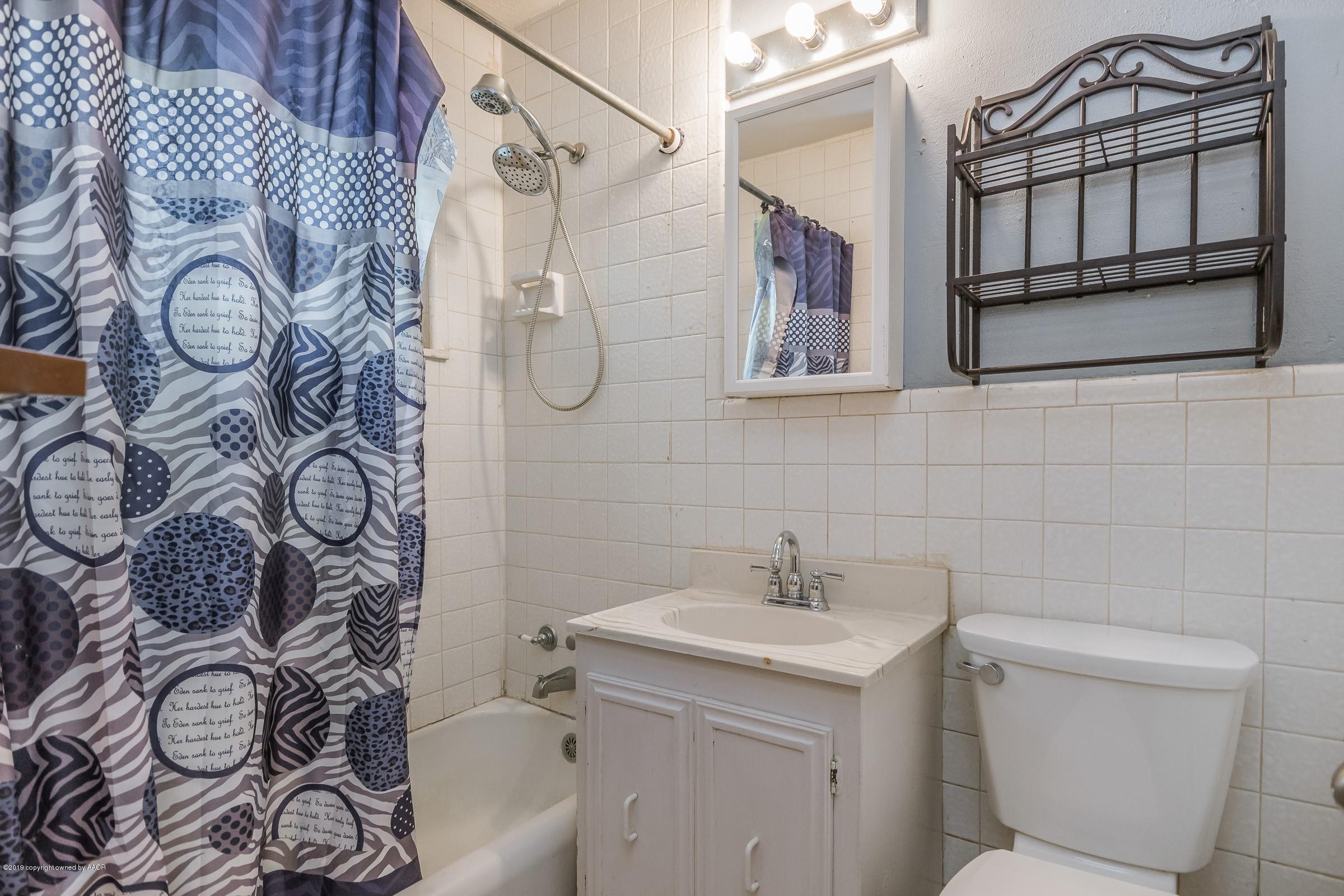 4318 Cline Road Amarillo, TX 79110 - Photo 15 of 21 a bathroom with a sink toilet and shower