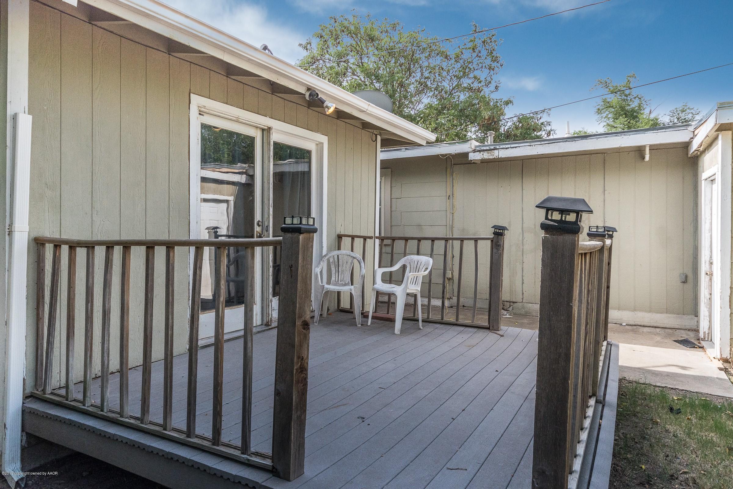 4318 Cline Road Amarillo, TX 79110 - Photo 17 of 21 a view of a porch with a table and chairs and wooden floor