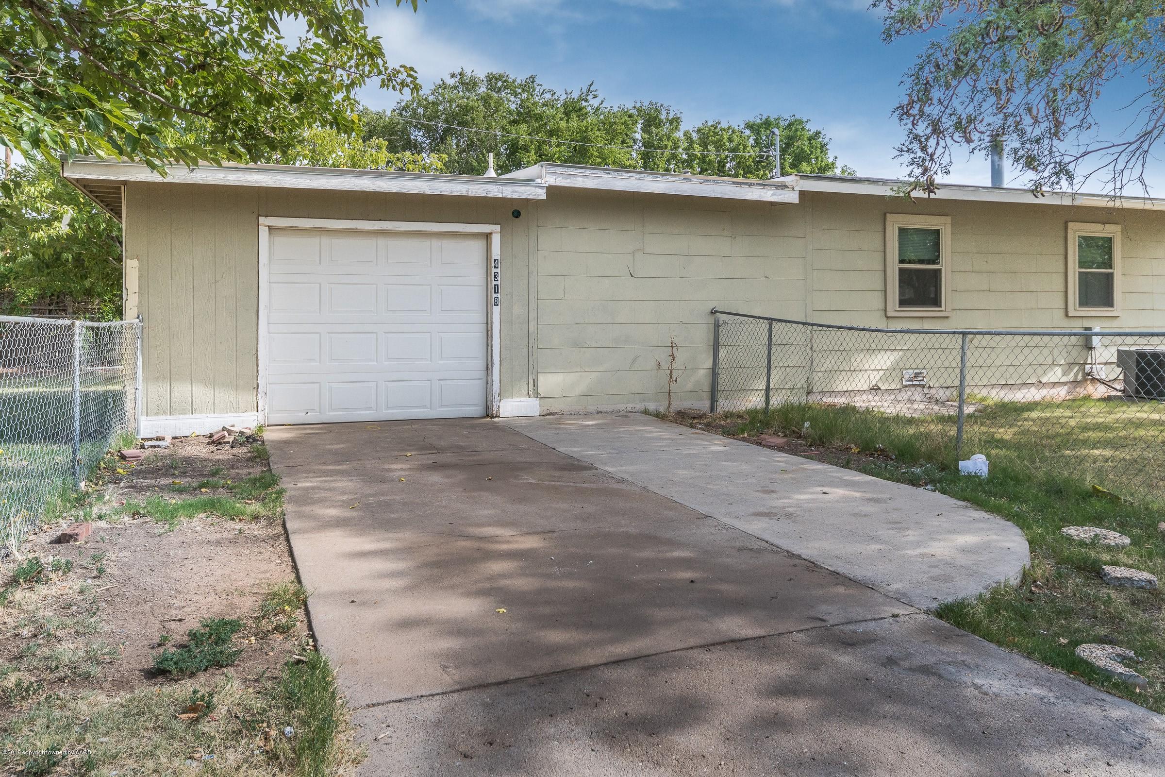 4318 Cline Road Amarillo, TX 79110 - Photo 20 of 21 a front view of a house with a yard and garage