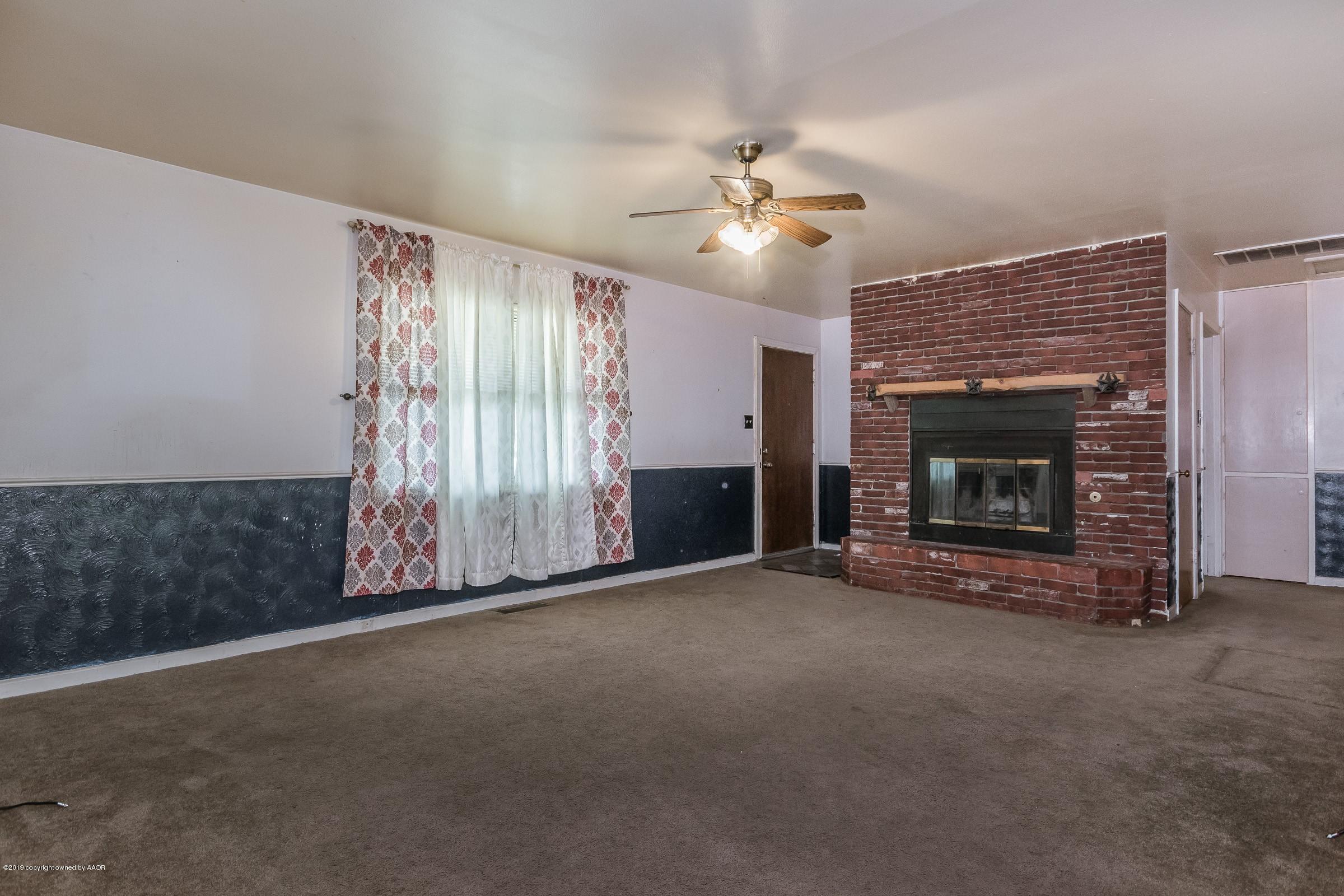 4318 Cline Road Amarillo, TX 79110 - Photo 4 of 21 a view of an empty room with window and fireplace