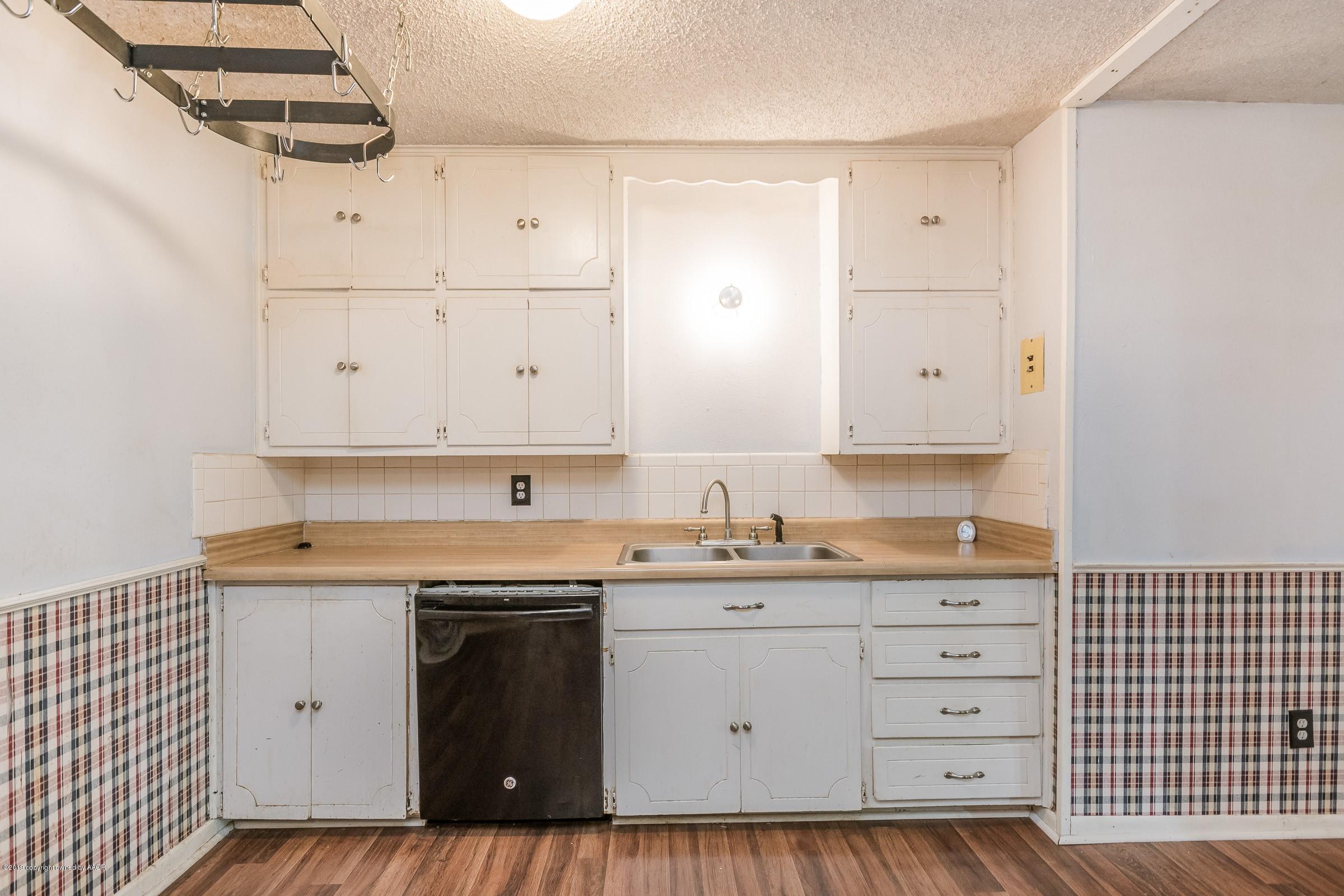 4318 Cline Road Amarillo, TX 79110 - Photo 6 of 21 a kitchen with granite countertop white cabinets and white appliances