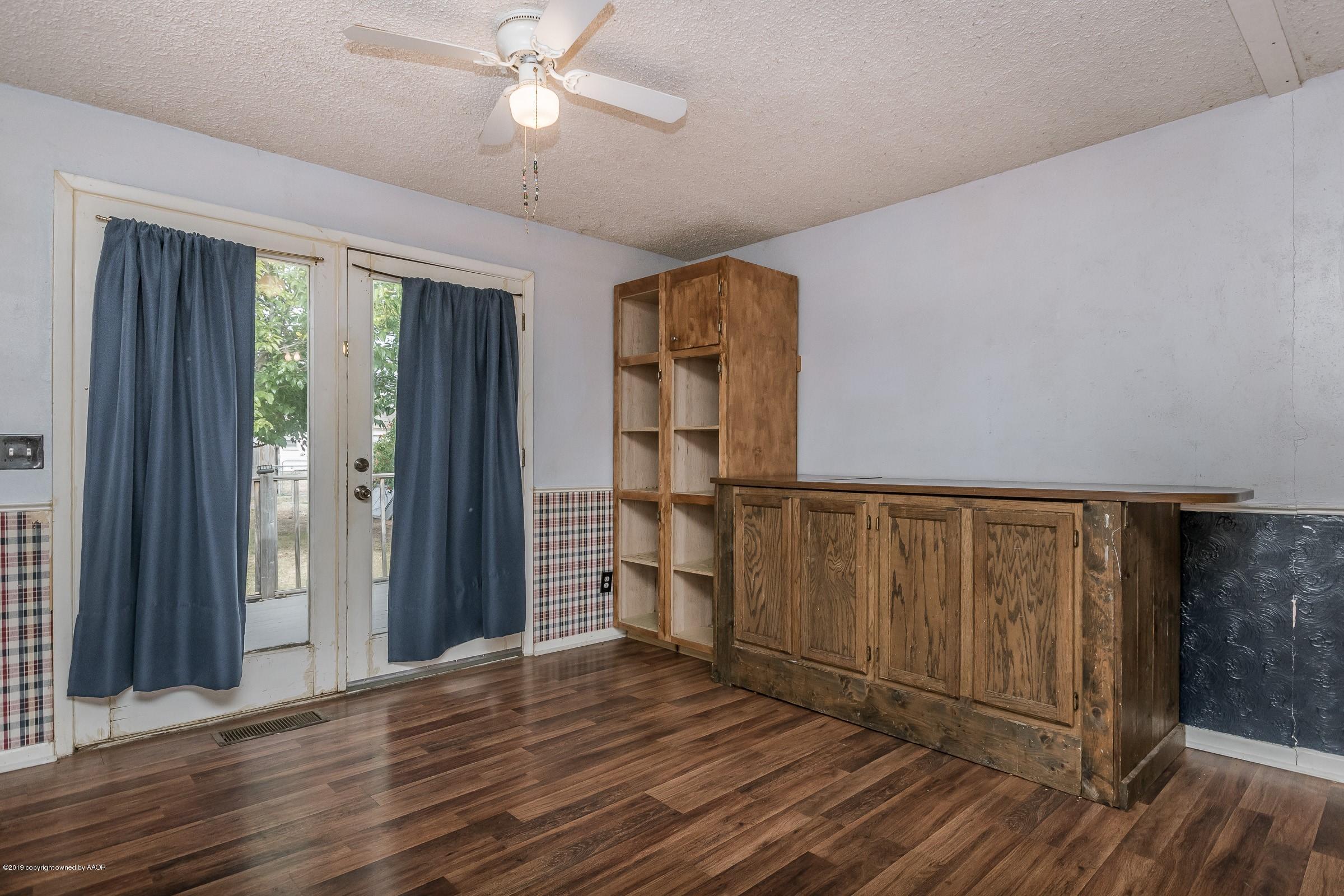4318 Cline Road Amarillo, TX 79110 - Photo 7 of 21 wooden floor in an empty room with a window