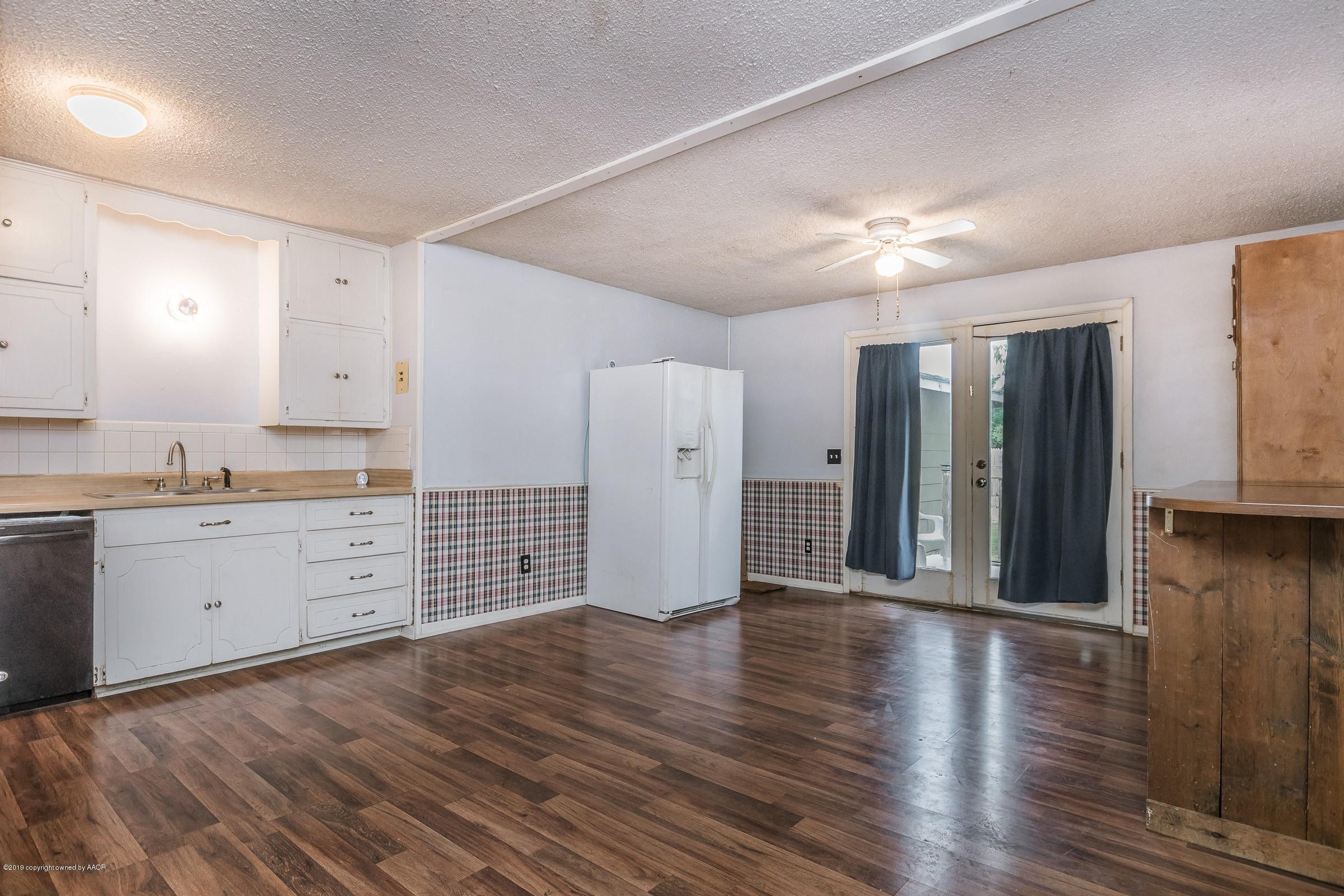 4318 Cline Road Amarillo, TX 79110 - Photo 8 of 21 a view of a kitchen with wooden floor and a sink