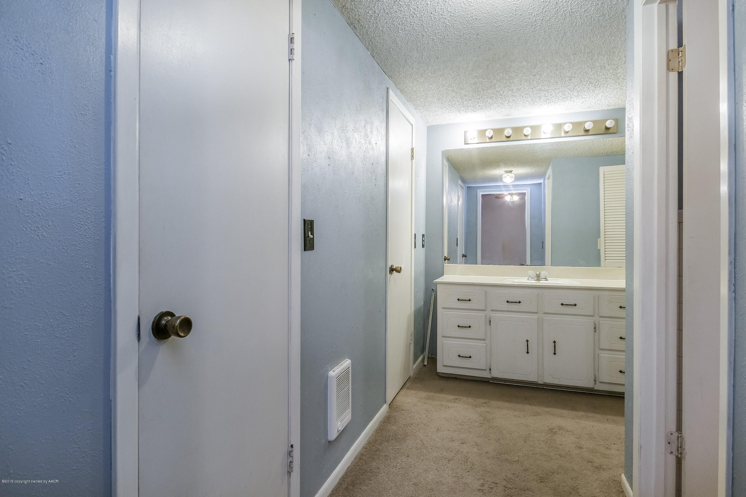 4318 Cline Road Amarillo, TX 79110 - Photo 10 of 21 a bathroom with a granite countertop sink a mirror and a