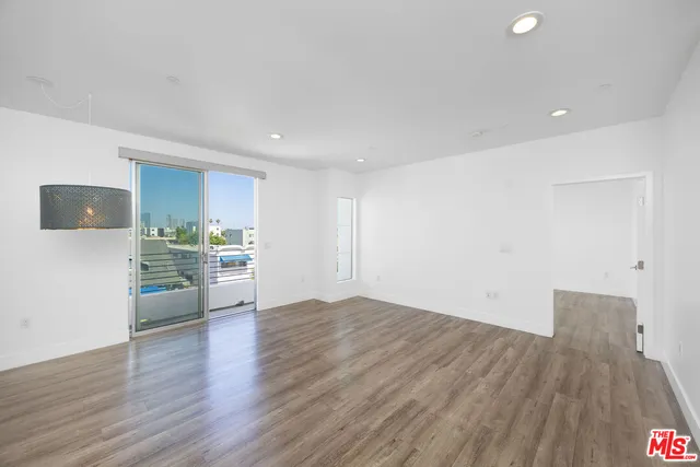 a view of a kitchen with a sink and a refrigerator