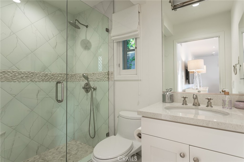 865 Fen Way Laguna Beach, CA 92651 - Photo 17 of 27 a bathroom with a granite countertop sink toilet and shower