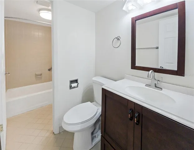 a bathroom with a sink vanity and a mirror