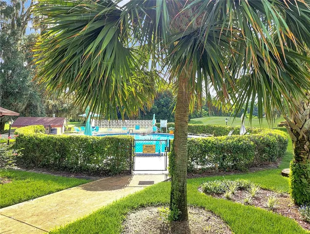 a view of an house with swimming pool and yard