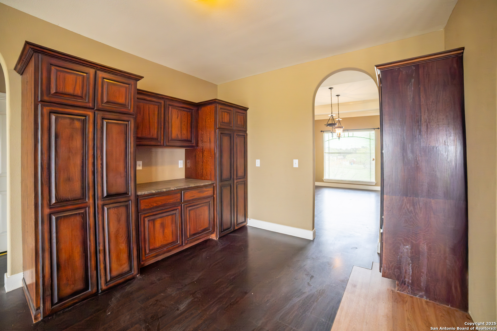 12219 Course View Drive San Antonio, TX 78221 - Photo 14 of 29 an empty room with wooden floor cabinet and front door
