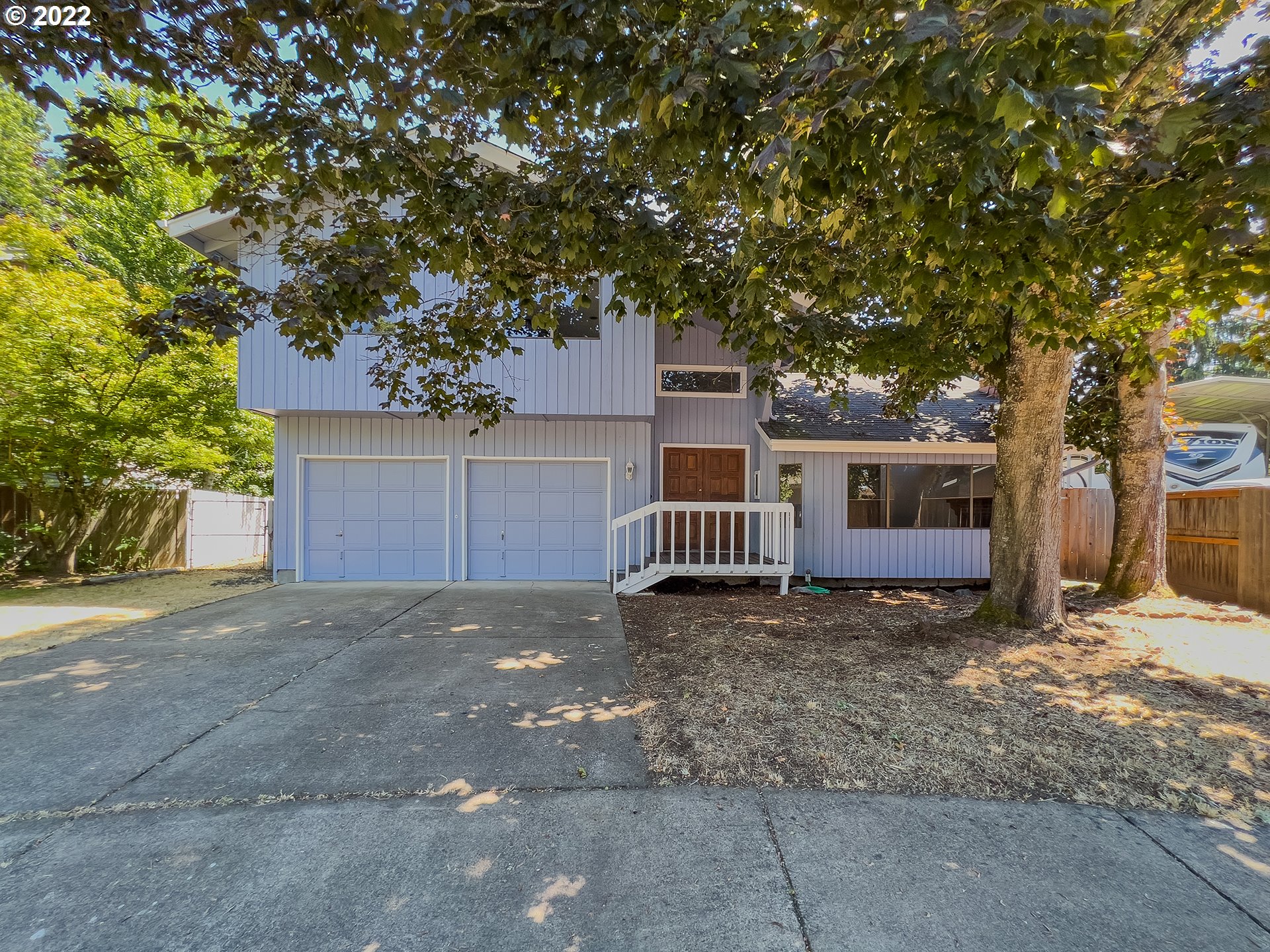 635 71st Street Springfield, OR 97478 - Photo 30 of 31 a view of a house with large tree and wooden fence