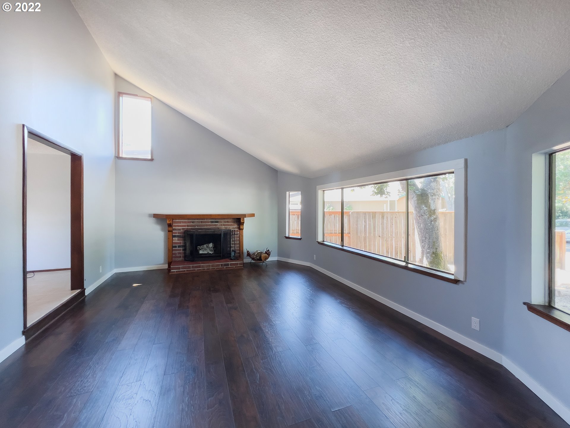 635 71st Street Springfield, OR 97478 - Photo 5 of 31 a view of an empty room with wooden floor fireplace and a window