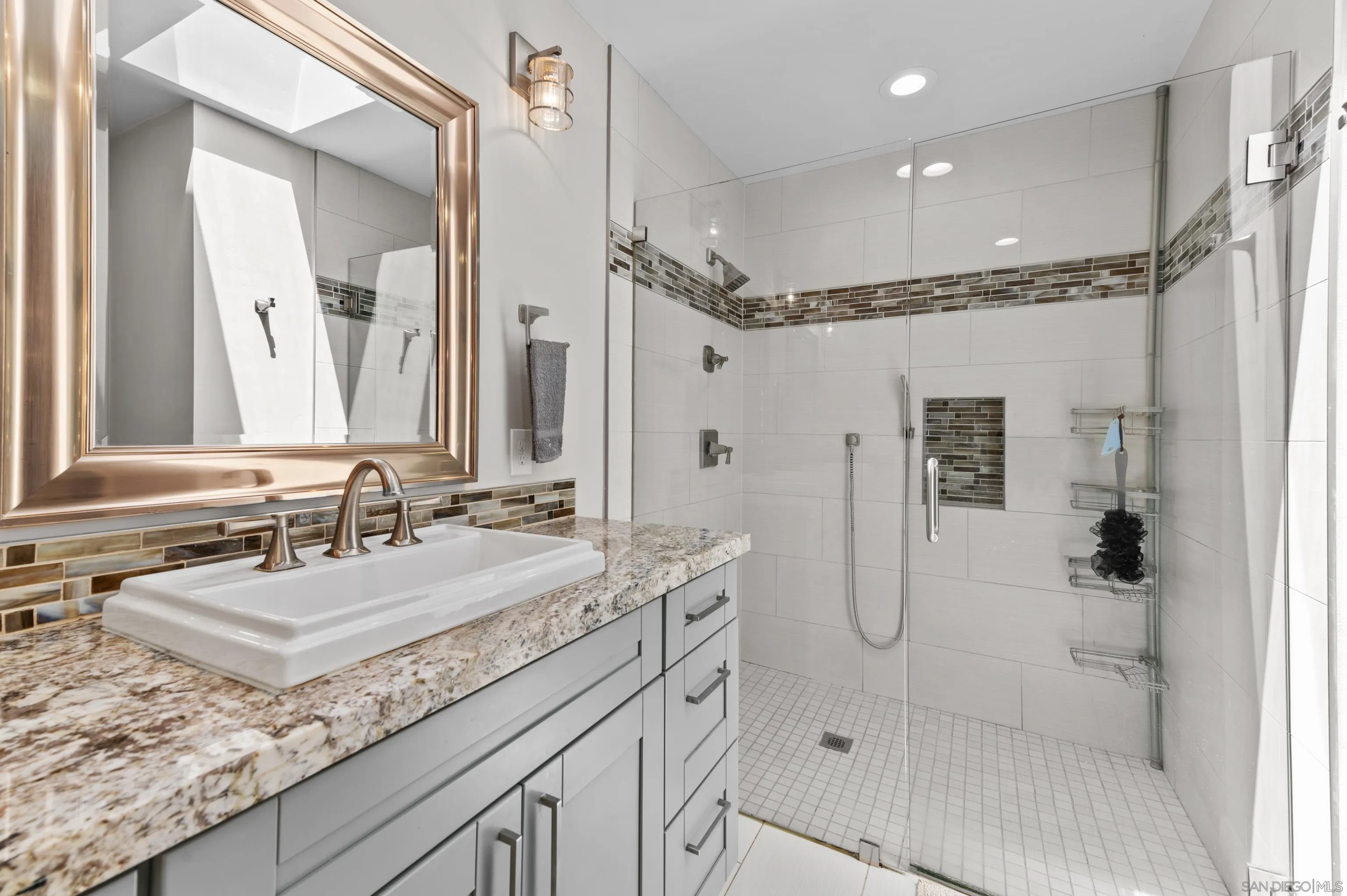 2950 Olive View Road Alpine, CA 91901 - Photo 11 of 29 a bathroom with a granite countertop sink a mirror a glass door a shower and vanity