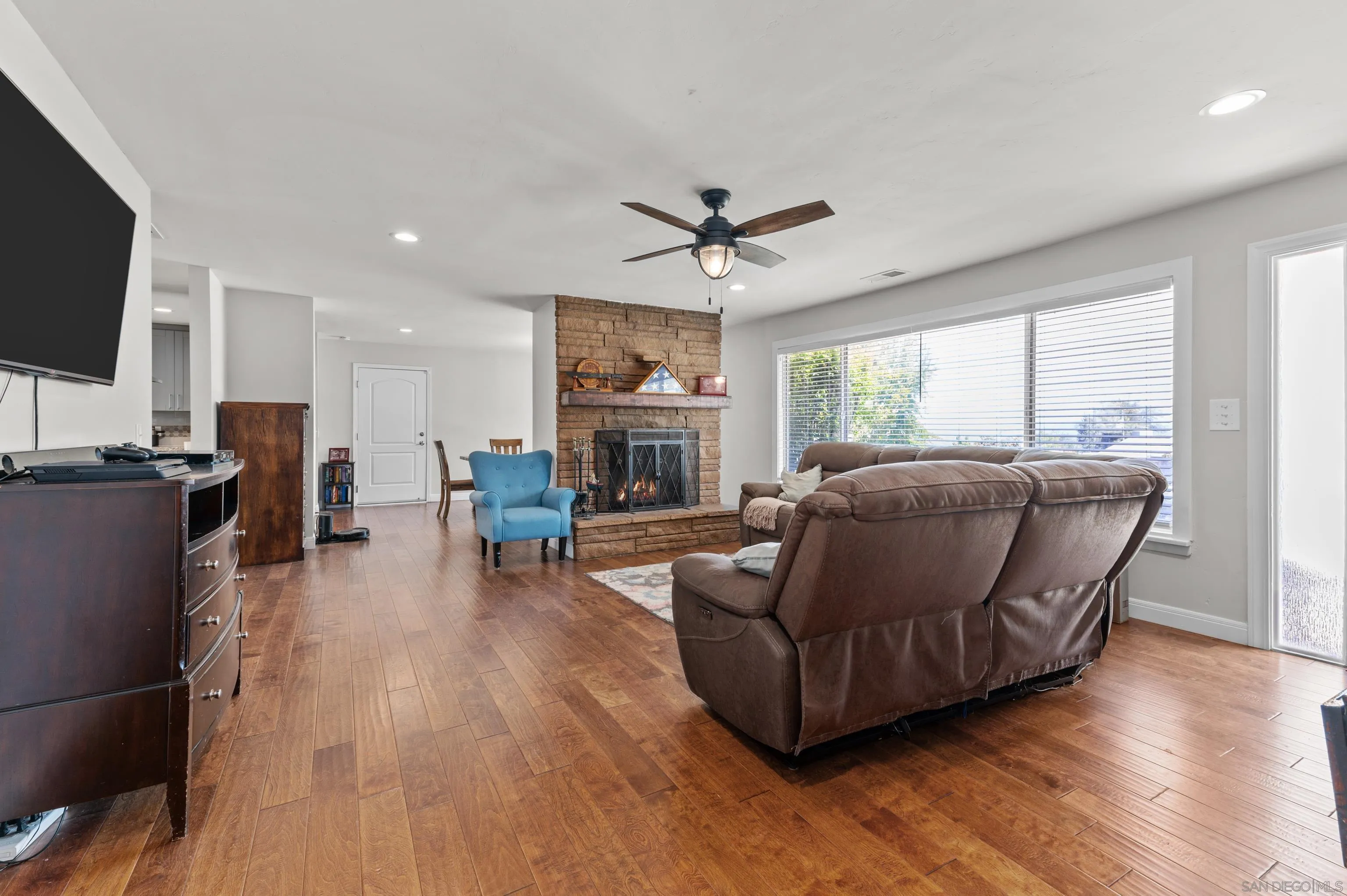 2950 Olive View Road Alpine, CA 91901 - Photo 4 of 29 a living room with furniture a flat screen tv and wooden floor