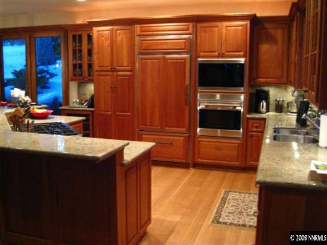 161 Chimney Rock Road Stateline, NV 89449 - Photo 4 of 6 a kitchen with stainless steel appliances wooden cabinets and a counter top space