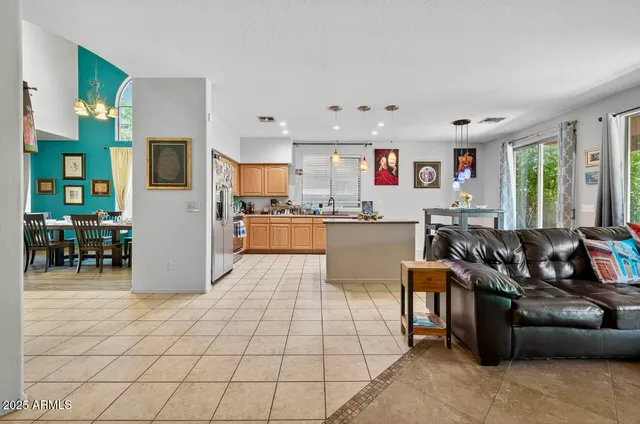 a living room with furniture and a kitchen