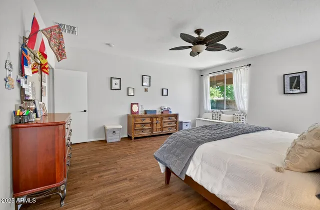 a spacious bedroom with a bed and a chandelier