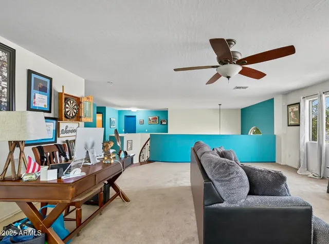 a living room with furniture and a book shelf
