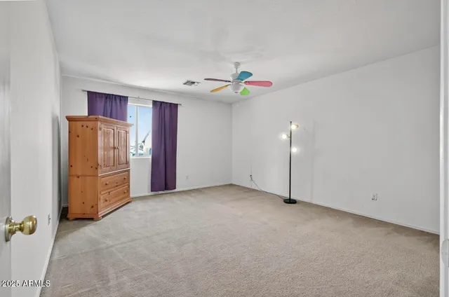 an empty room with closet and cabinet