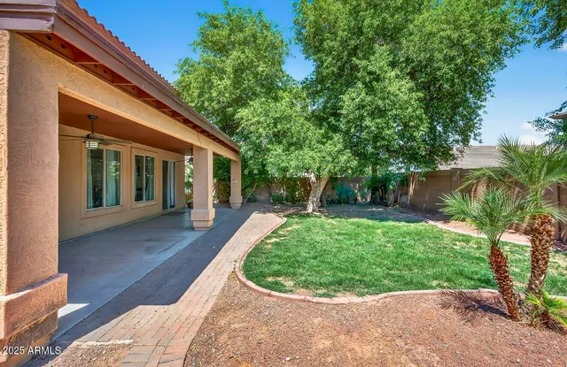 a front view of a house with a yard and trees