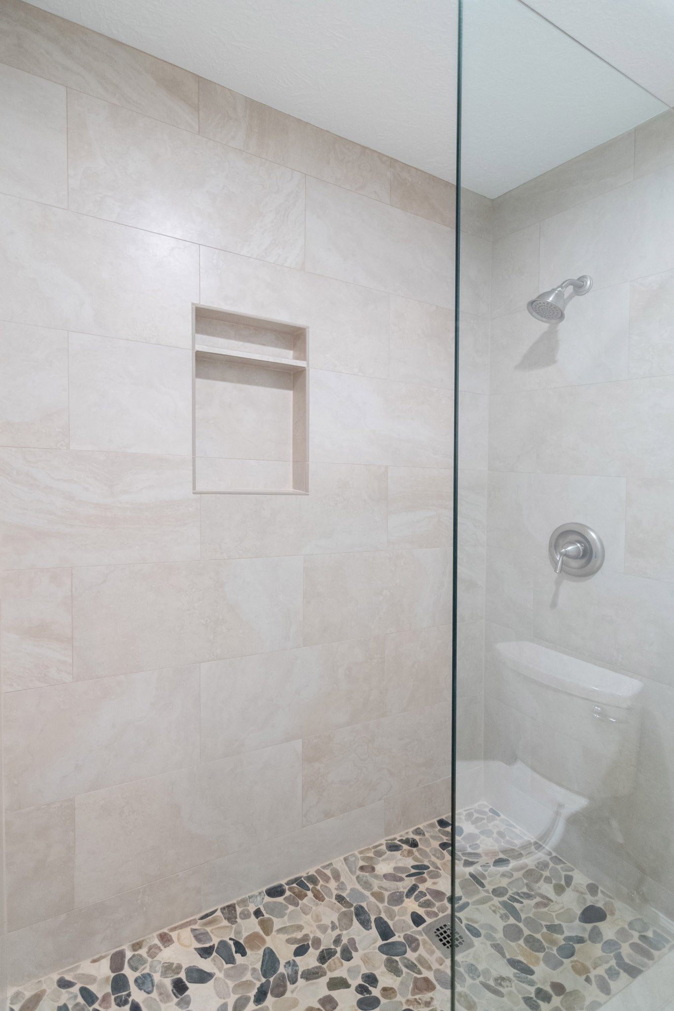 10 Coralvine Court Spring, TX 77380 - Photo 27 of 34 Bath 2 has gorgeous walk-in shower with tile surround, decorative tile flooring and frameless glass panel.