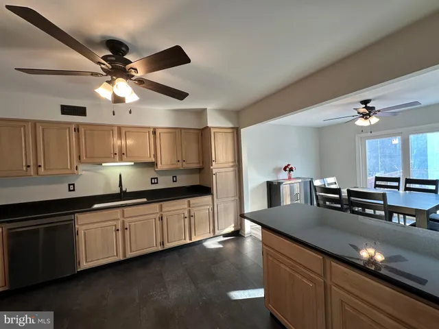 a kitchen with stainless steel appliances a refrigerator a stove top oven a sink and dishwasher