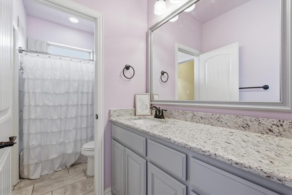 160 Vista Ridge North Decatur, TX 76234 - Photo 28 of 40 a bathroom with a granite countertop sink toilet and shower