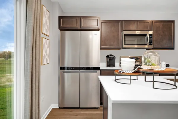 a kitchen with stainless steel appliances a refrigerator and microwave
