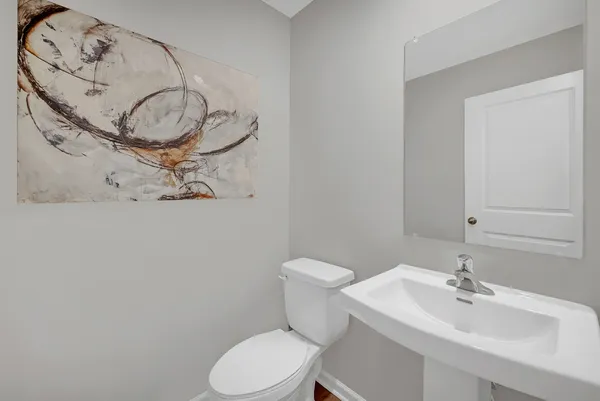 a bathroom with a sink and mirror with toilet