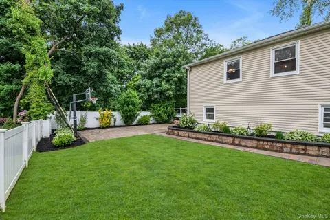 a front view of a house with a yard and trees