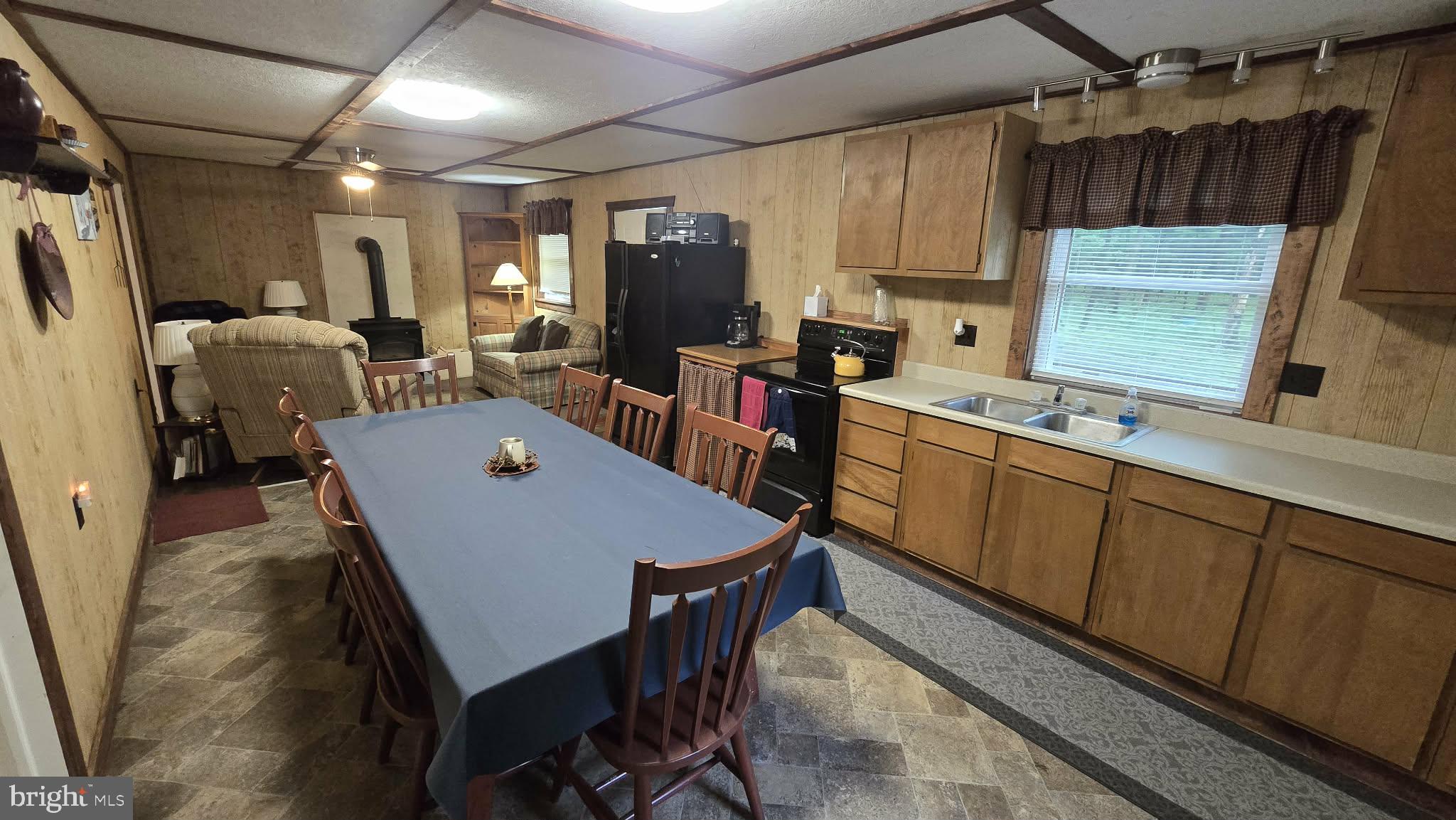8245 Aughwick Road Fort Loudon, PA 17224 - Photo 12 of 26 a kitchen with a table chairs refrigerator and microwave