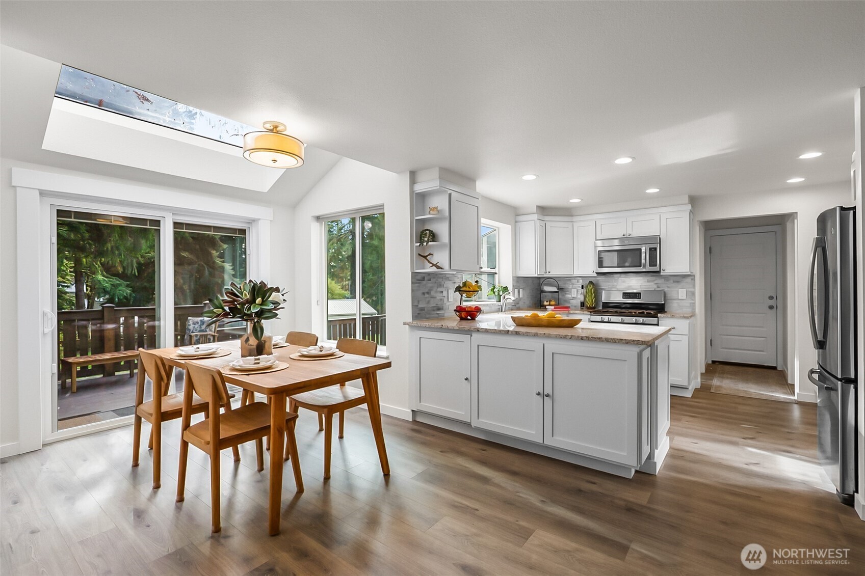 19462 324th Avenue Northeast Duvall, WA 98019 - Photo 11 of 40 a kitchen with white cabinets and stainless steel appliances