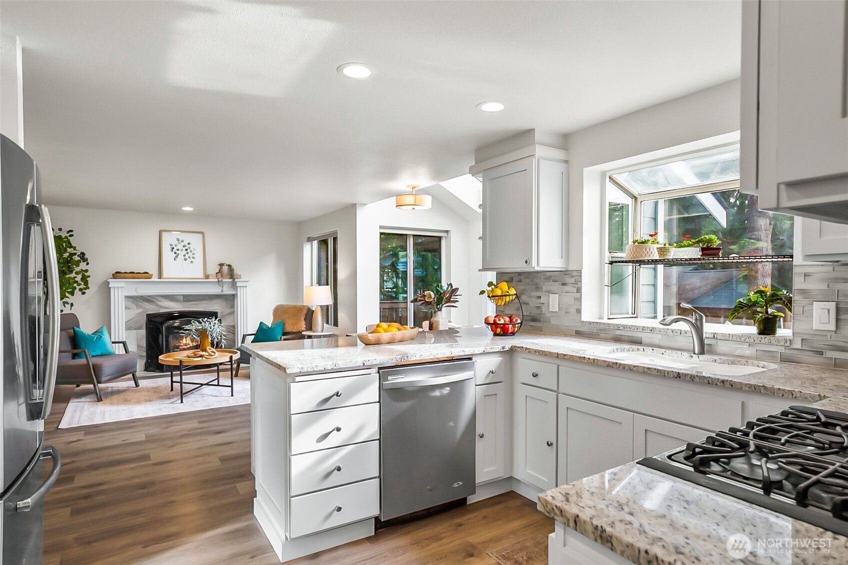 19462 324th Avenue Northeast Duvall, WA 98019 - Photo 13 of 40 a kitchen with a stove a sink and a fireplace