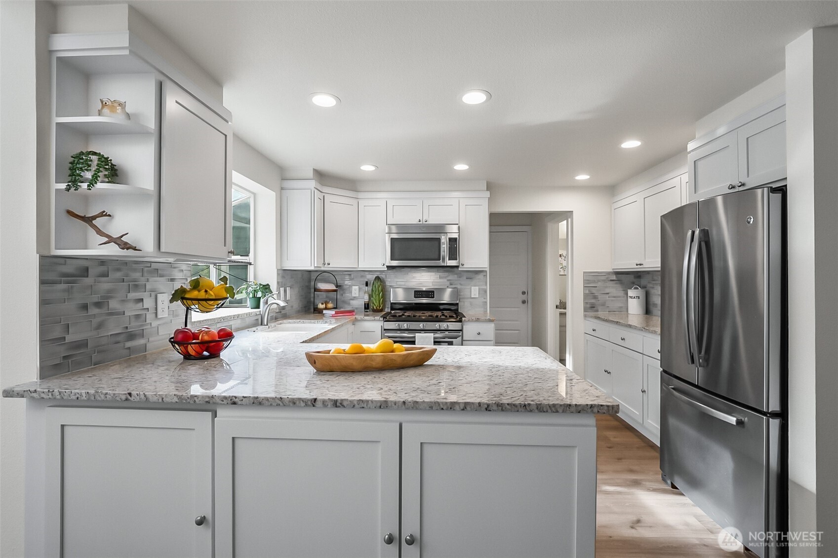 19462 324th Avenue Northeast Duvall, WA 98019 - Photo 15 of 40 a kitchen with a refrigerator a sink and wooden cabinets