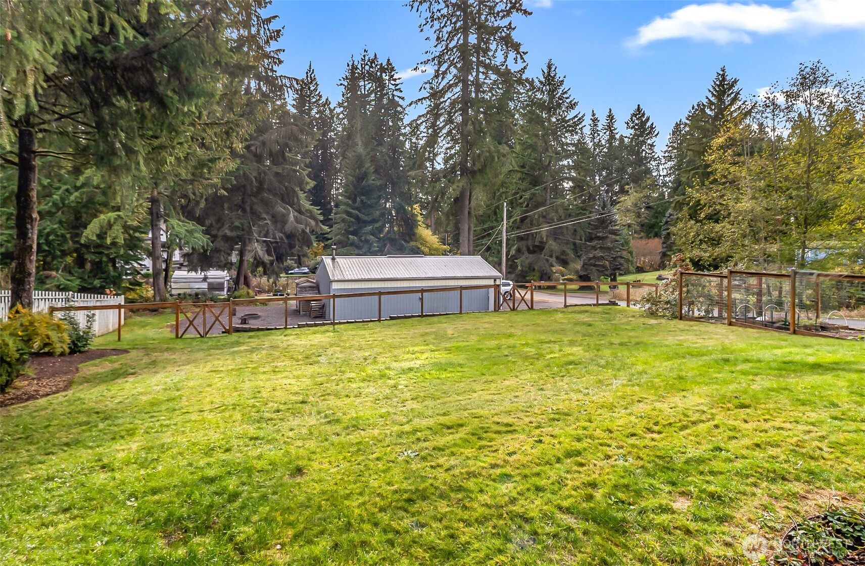 19462 324th Avenue Northeast Duvall, WA 98019 - Photo 35 of 40 a view of a swimming pool with a bench and trees around