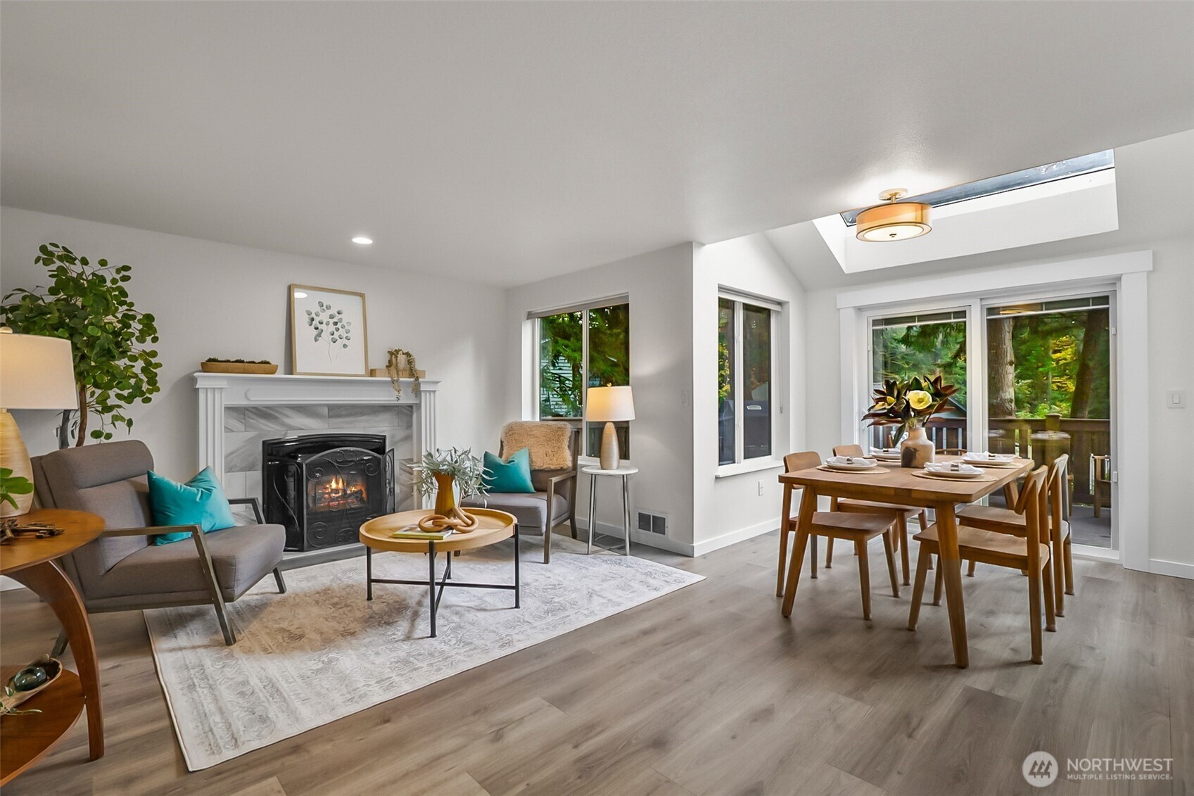 19462 324th Avenue Northeast Duvall, WA 98019 - Photo 9 of 40 a living room with furniture a fireplace and a table