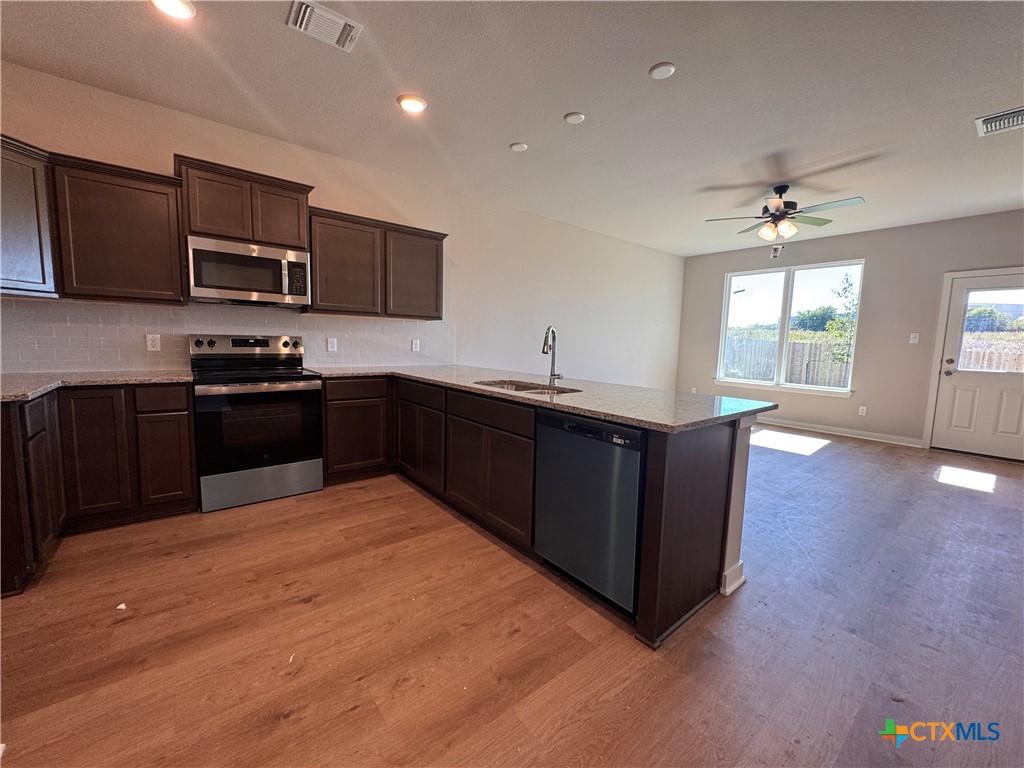 409 University Avenue Troy, TX 76579 - Photo 5 of 20 a kitchen with stainless steel appliances granite countertop a sink dishwasher stove and refrigerator