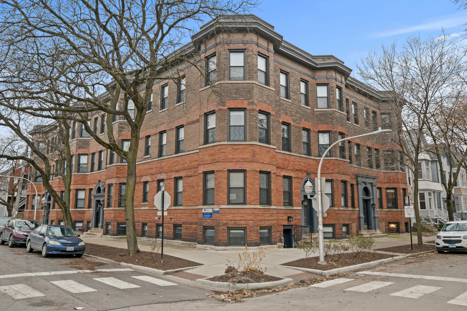 Undisclosed Address Chicago, IL 60657 - Photo 1 of 13 a front view of a building with lot of cars and trees