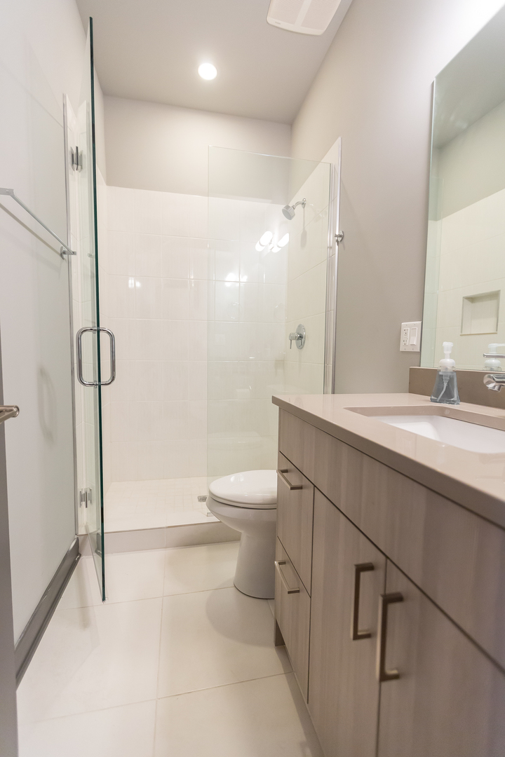 Undisclosed Address Chicago, IL 60657 - Photo 11 of 13 a bathroom with a sink a toilet and shower