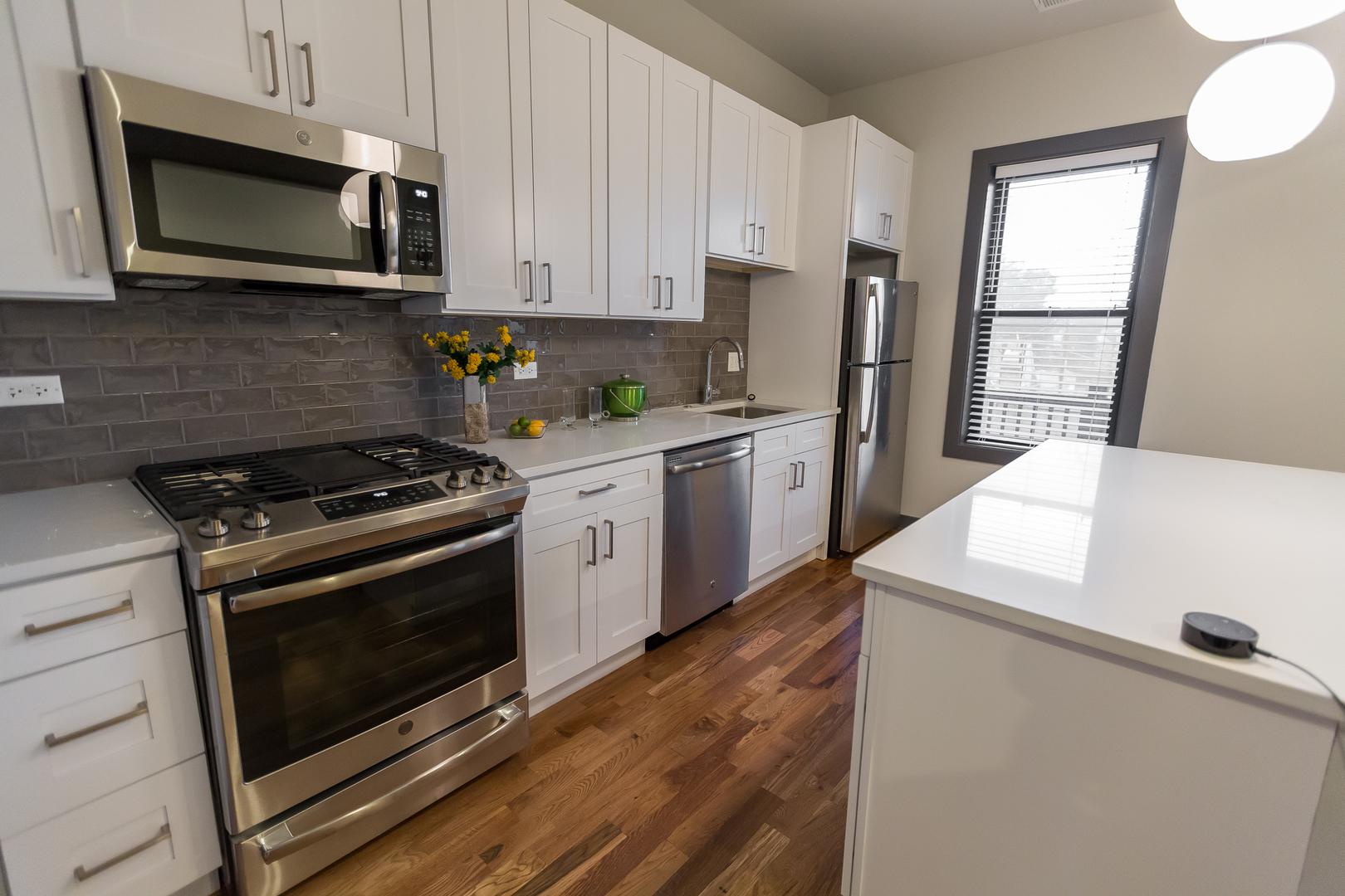 Undisclosed Address Chicago, IL 60657 - Photo 3 of 13 a kitchen with stainless steel appliances a stove microwave and sink