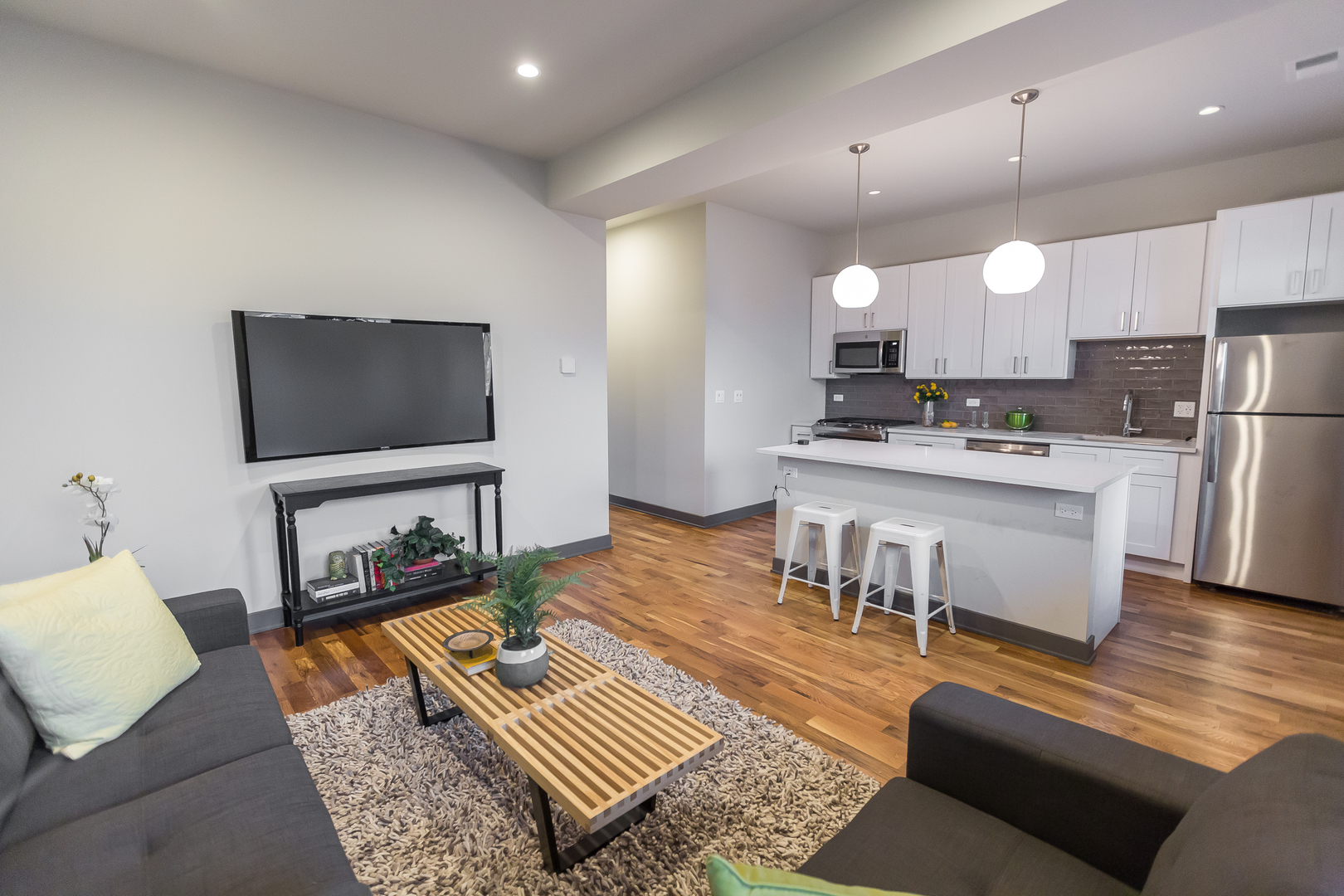 Undisclosed Address Chicago, IL 60657 - Photo 4 of 13 a living room with furniture and a flat screen tv